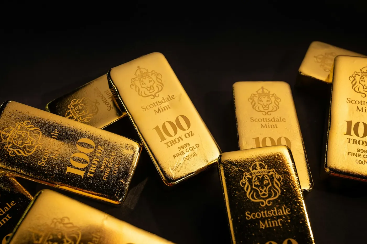 Gold bars scattered across a dark surface