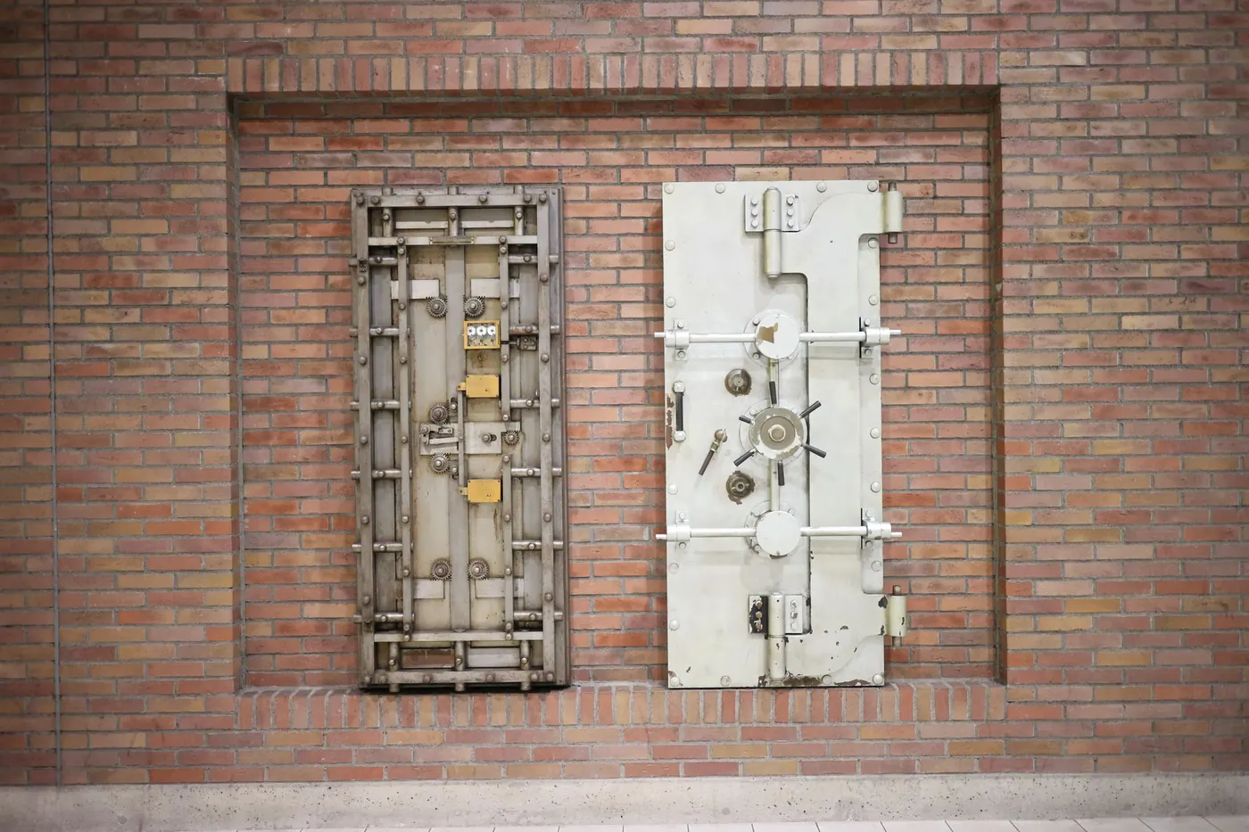 Two steel vault doors set into an old brick wall