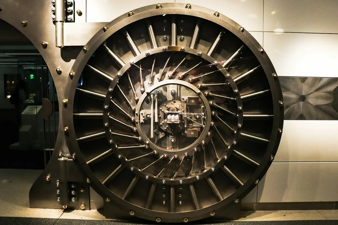 The round steel door of a bank vault, bolt work exposed
